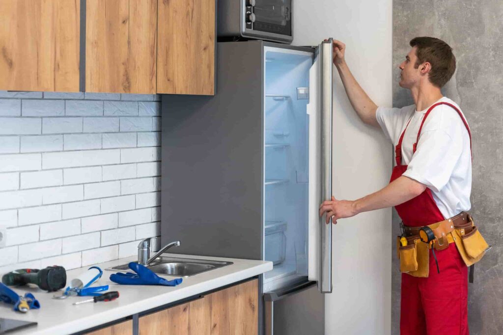 male worker repairing refrigerator with screwdrive 2026 01 07 05 27 02 utc scaled 2