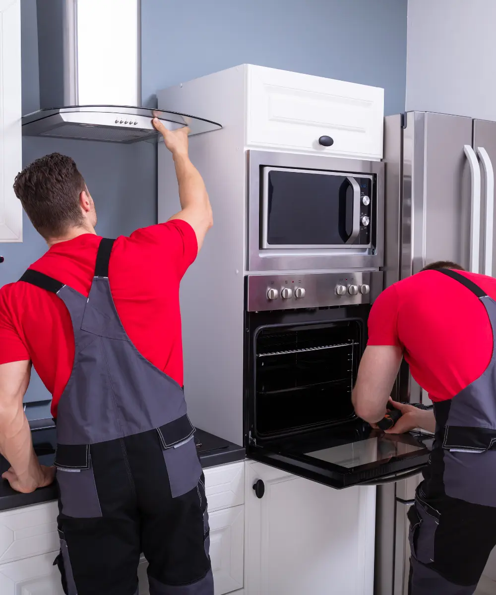 men repair oven
